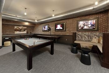 Game room with pool table and booth seating